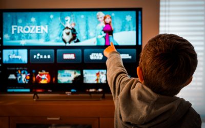 Barcelona, Spain. May 2019: Back view image of cute little boy watching the new Disney plus streaming service and pointing at the TV screen.Illustrative editorial